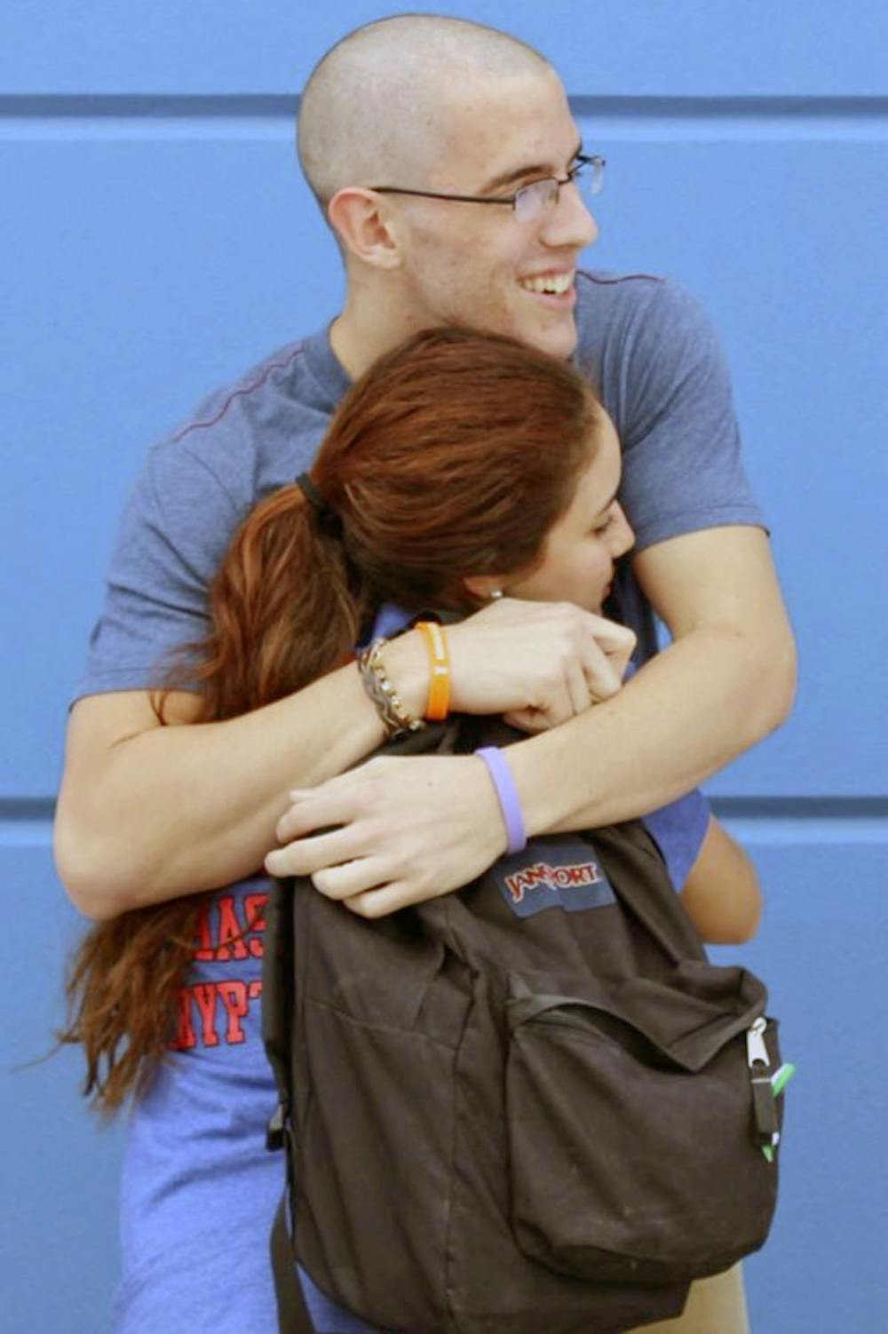 <p>Erika Atencio, a UF biology freshman, hugs her friend Ian Supra, who has battled stage 4 esophageal cancer for more than a year. After hearing of Supra’s diagnosis in January 2014, Atencio and a group of her friends raised money to offset Supra’s medical bills by selling “Supra Strong,” bracelets and T-shirts.</p>