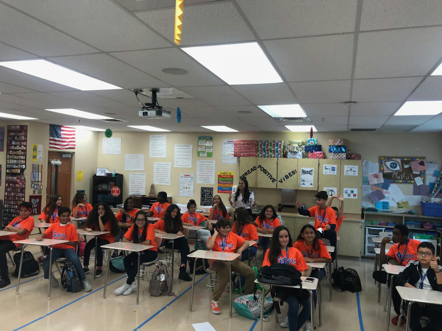 Students in their homeroom class at Palm Springs Community Middle School in West Palm Beach smile after receiving a box full of Gator shirts. UF was the only school of 20 to respond to the students request for shirts to celebrate College Friday. 