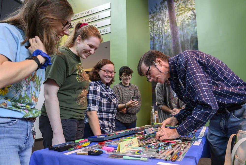 Jim Grantham, right, tells stories about his floaty pen collection to evengoers during the&nbsp;41st&nbsp;Collectors Day at the Florida Museum of Natural History. Collectors Day is the Museum’s longest running event and attracts regional collectors of a variety of objects such as potato mashers, model ships, pop-up books and trains, each year.