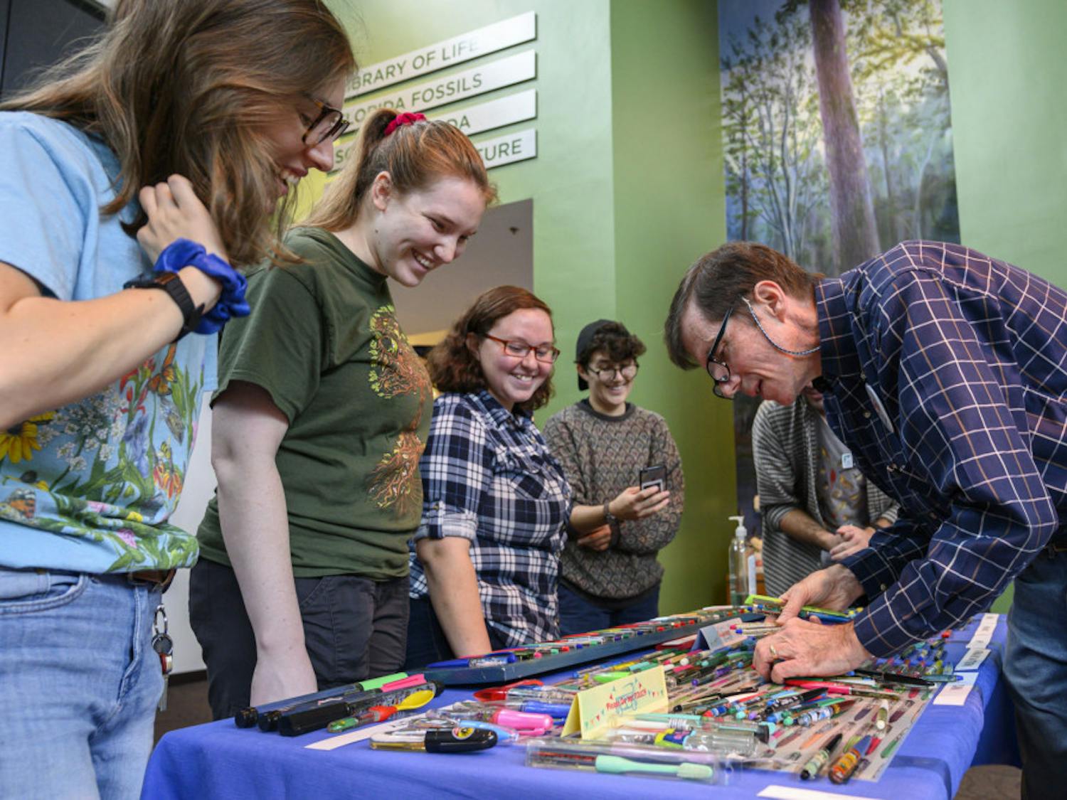 Jim Grantham, right, tells stories about his floaty pen collection to evengoers during the 41st Collectors Day at the Florida Museum of Natural History. Collectors Day is the Museum’s longest running event and attracts regional collectors of a variety of objects such as potato mashers, model ships, pop-up books and trains, each year.