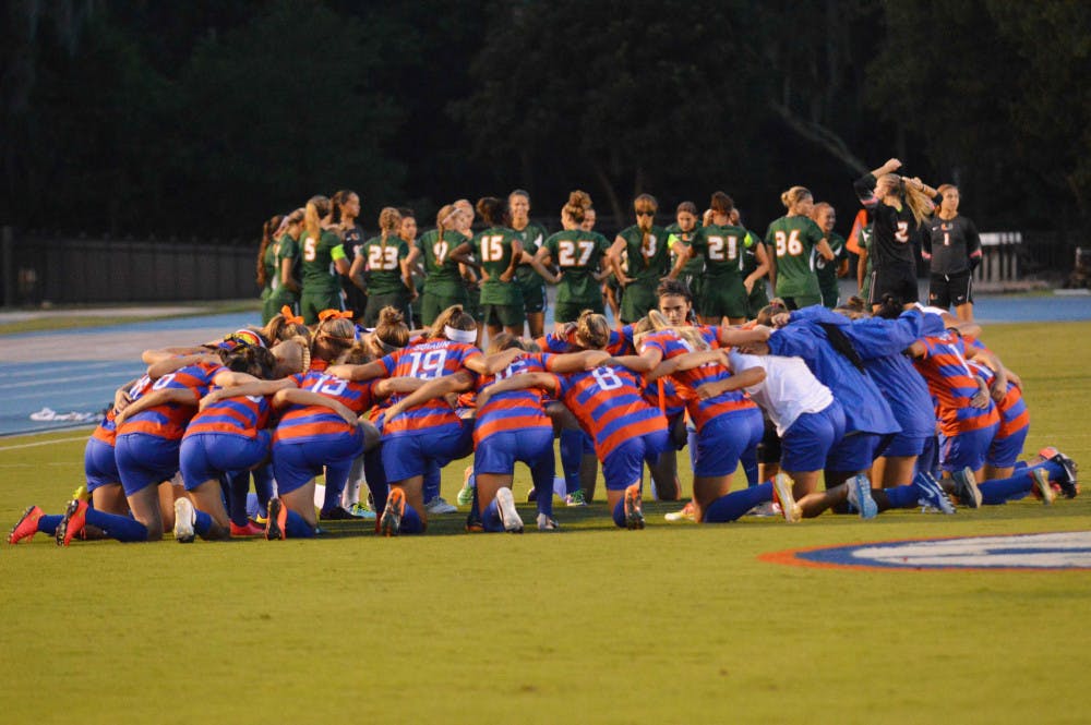 <p>Florida (front) huddles prior to its 3-0 win against Miami on Aug. 22 at James G. Pressly Stadium.</p>