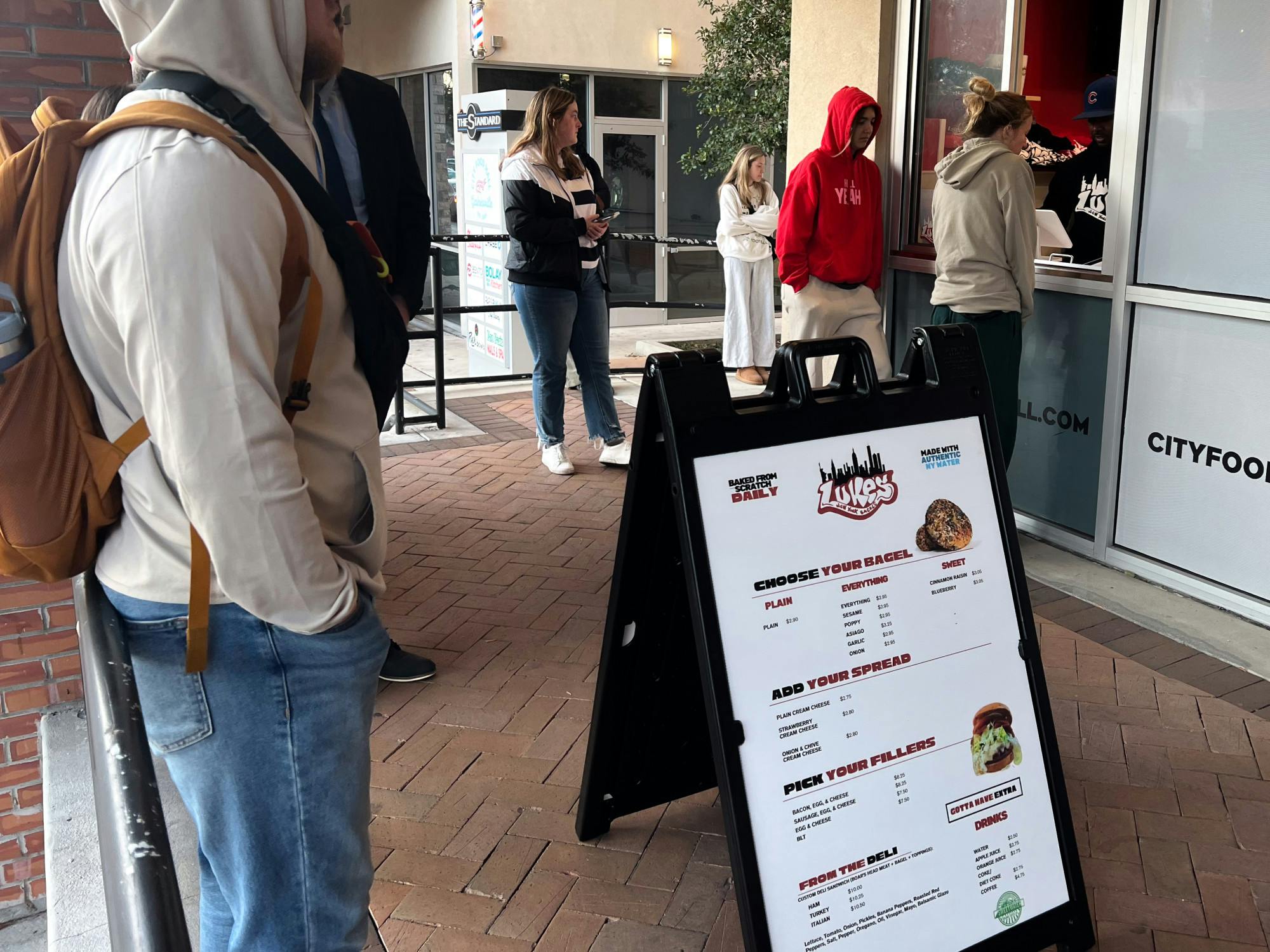 Customers order at the window of Luke’s New York Bagels’ new location at City Food Hall on Thursday, Jan. 30, 2025. 