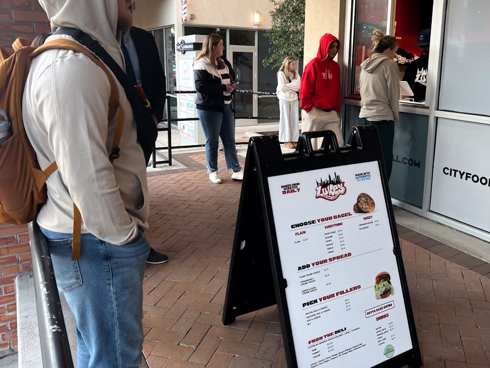 <p>Customers order at the window of Luke’s New York Bagels’ new location at City Food Hall on Thursday, Jan. 30, 2025. </p>