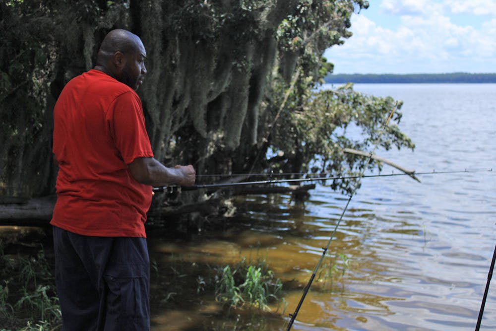 <p>Ron Johnson, 55, spends his afternoon fishing at Newnans Lake on Saturday, July 29, 2023. <br/><br/></p>