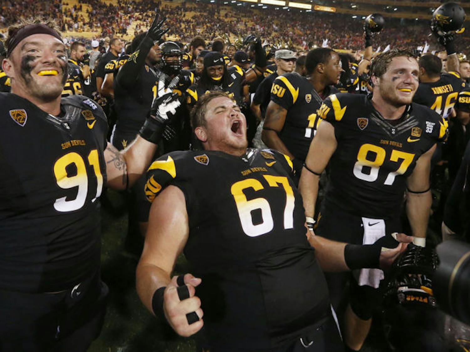Arizona State’s Jake Sheffield (91), Kody Koebensky (67) and Chris Coyle (87) celebrate a 32-30 victory against Wisconsin on Saturday in Phoenix. Arizona State faces Stanford this weekend.