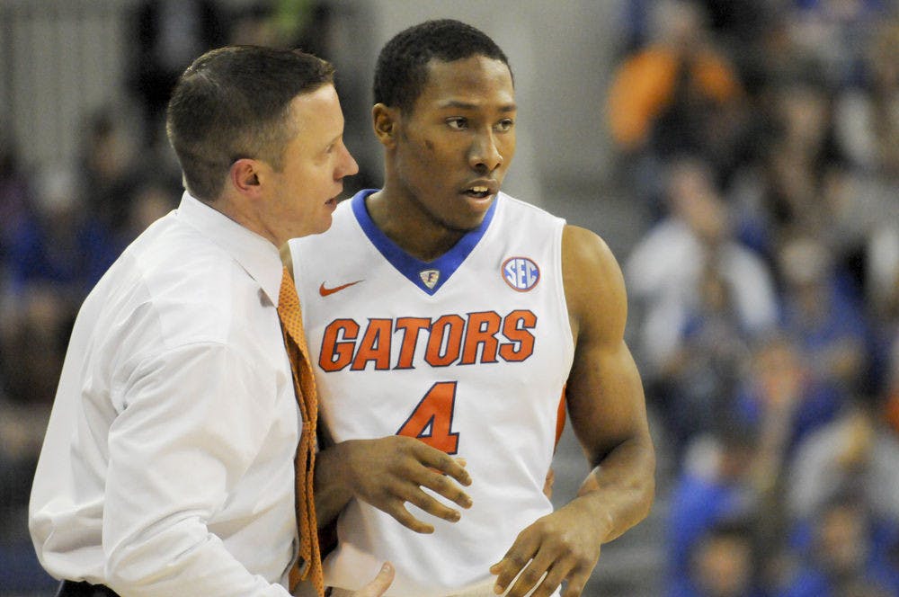 <p>UF coach Mike White talks with guard KeVaughn Allen during Florida’s 77-63 win against Georgia on Jan.2, 2016, in the O’Connell Center.</p>