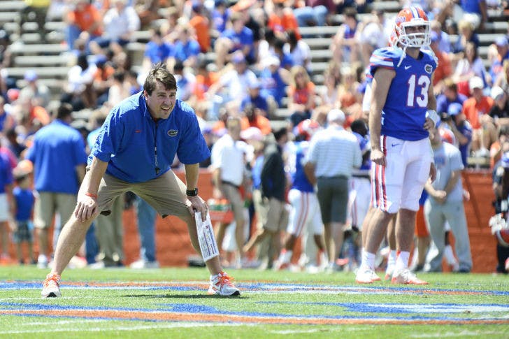 Coach Will Muschamp watches drills during the Orange and Blue Debut on Saturday at Ben Hill Griffin Stadium. Muschamp altered the event’s format due to multiple injuries affecting the Gators’ depth.