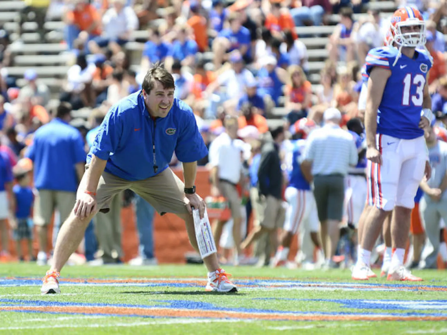 Coach Will Muschamp watches drills during the Orange and Blue Debut on Saturday at Ben Hill Griffin Stadium. Muschamp altered the event’s format due to multiple injuries affecting the Gators’ depth.