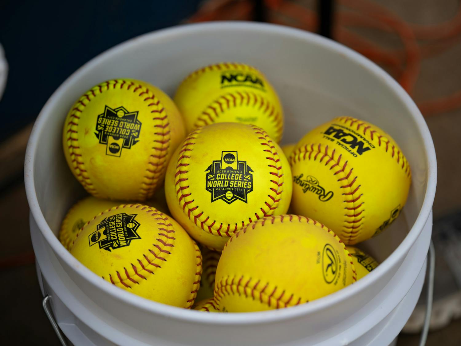 A bucket of softballs with the WCWS logo sit before the first game of the NCAA Women’s College World Series vs. the Texas Longhorns on Thursday, May 29, 2025, at Devon Park in Oklahoma City, Oklahoma.