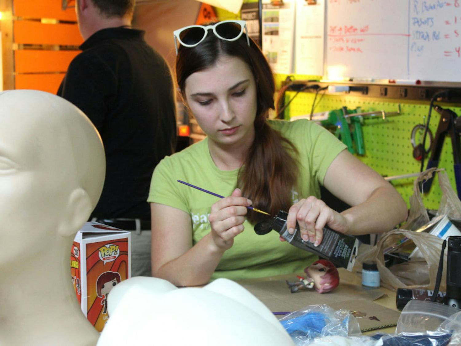 Jessica&nbsp;Hvozdovich, 24, repaints a figurine of Lilith from the video game "Borderlands 2." She was one of about 15 people who attended a cosplay workshop event at Hackerspace.