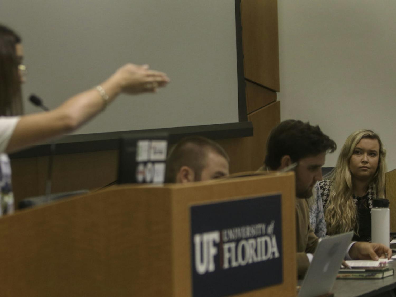 Libby Shaw (right), senate president for University of Florida student government, receives criticism Tuesday during public comment over the removal of Inspire Senators Ashley Grabowski, the former senate minority leader, and Ben Lima. Eight people read statements from students, alumni and UF staff disagreeing with Shaws actions and asking for the reinstatement of Grabowski and Lima.