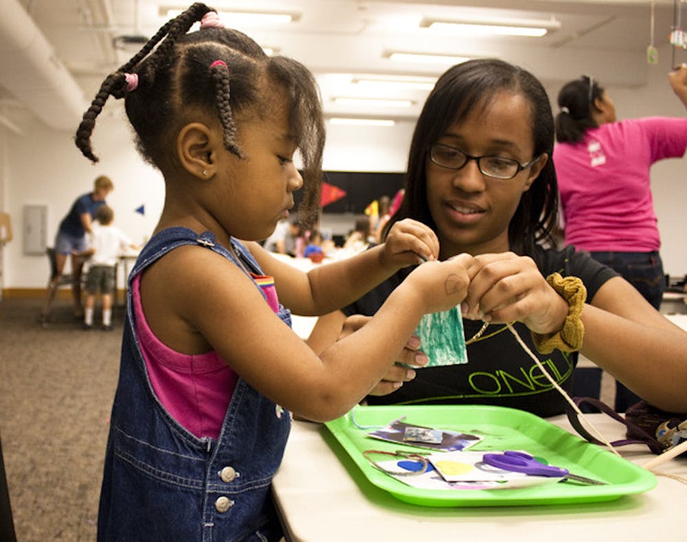 <p>Gainesville residents Morgan, 3, and her mother, Angela Donley, craft a mobile at the Samuel P. Harn Museum of Art's Family Day on Saturday.</p>