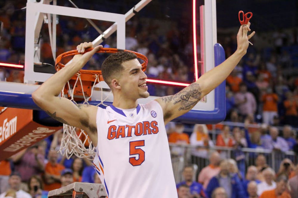 <p>Scottie Wilbekin cuts down the net after Florida’s 84-65 win against Kentucky on Saturday in the O’Connell Center.</p>