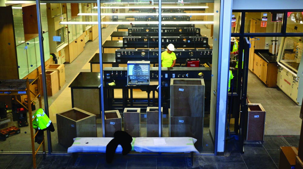 A view of the general chemistry lab from the stairs located perpendicular to them. The new general chemistry lab located on the first floor has 16 stations with the intent of accommodating 16 students per station for an estimated occupancy of 250. 