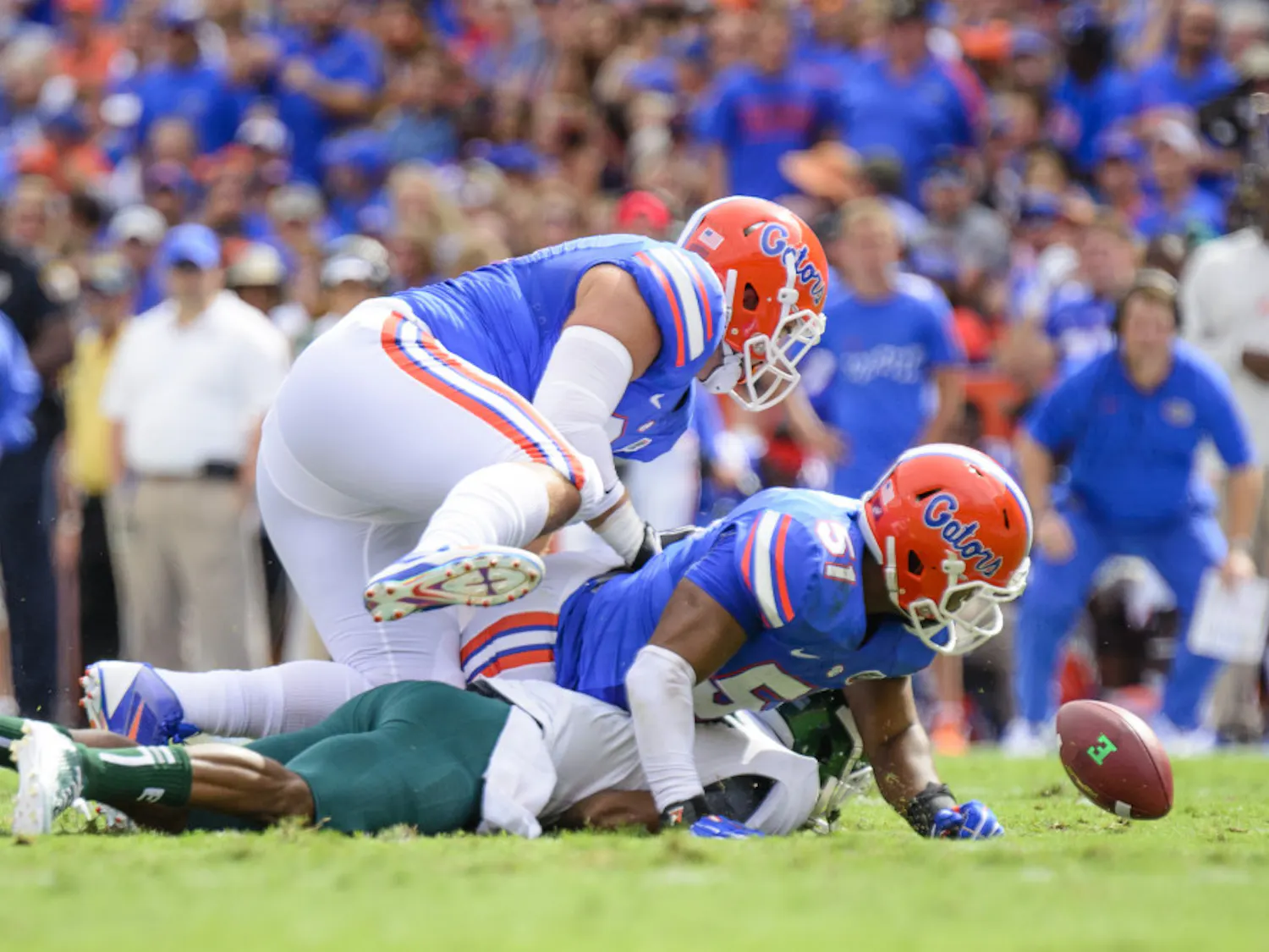 Michael Taylor and Caleb Brantly force Eastern Michigan quarterback Reginald Bell to fumble the ball during the Gators' 65-0 win against the Eagles on Saturday at Ben Hill Griffin Stadium.