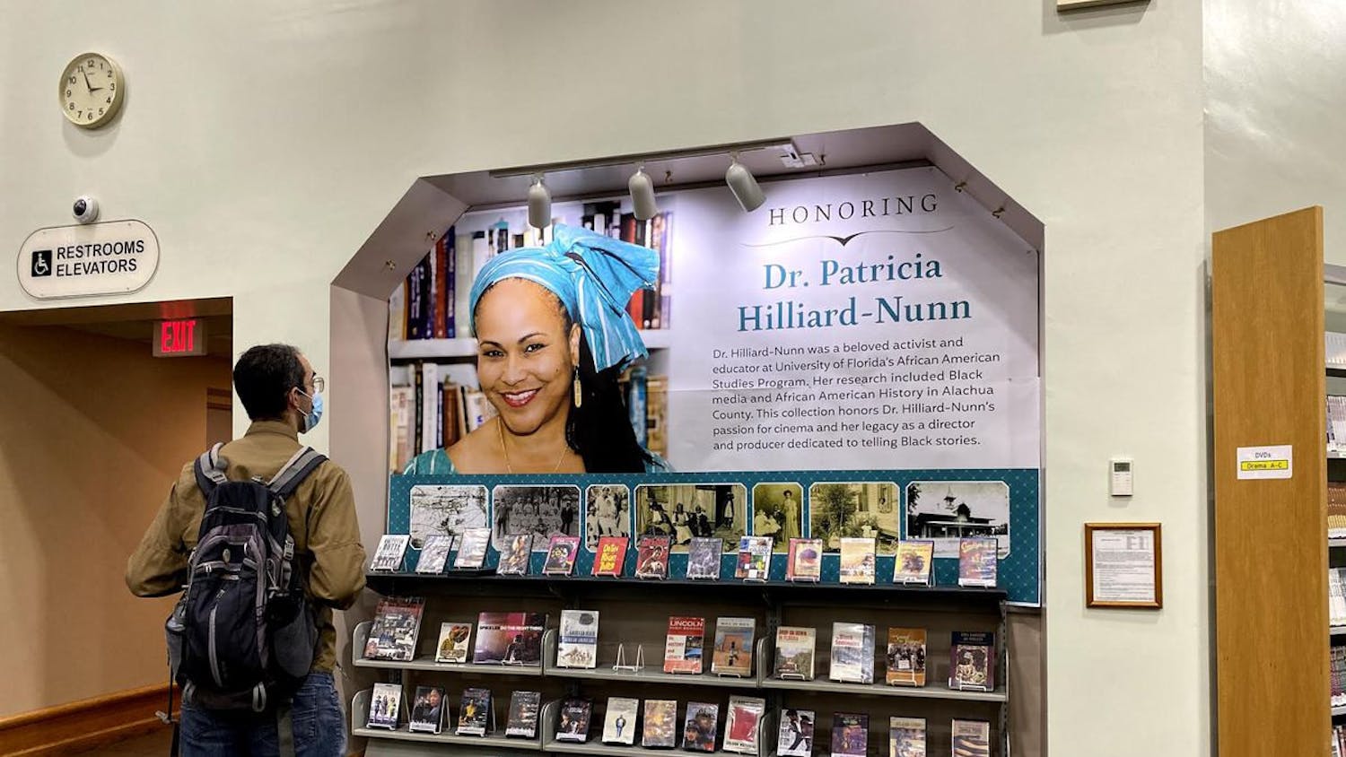 A man observes the collection of movies and books on the display honoring the late Patricia Hilliard-Nunn at the Headquarters Library. Hilliard-Nunn was an activist and adjunct associate professor at UF in the African American Studies Program who died on Aug. 5 at 57.