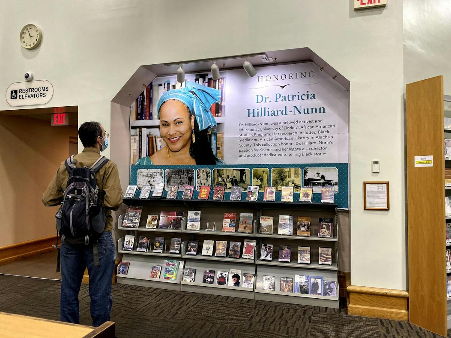 A man observes the collection of movies and books on the display honoring the late Patricia Hilliard-Nunn at the Headquarters Library. Hilliard-Nunn was an activist and adjunct associate professor at UF in the African American Studies Program who died on Aug. 5 at 57.