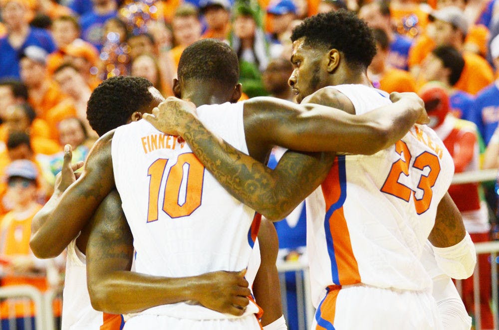 <p>Michael Frazier II (from left), Dorian Finney-Smith and Chris Walker huddle during Florida's 68-61 loss to No. 1 Kentucky on Saturday in the O'Connell Center.</p>
