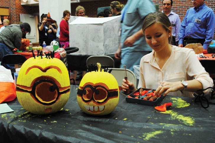 UF architecture junior Michelle Hook, 21, makes “Despicable Me” minions at the 31st Annual Pumpkin Carve-Off and carnival for patients at UF Health Shands Children’s Hospital on Monday.