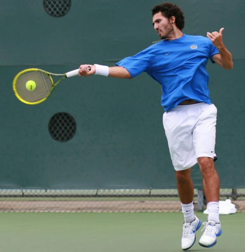 <p>Florida senior Nassim Slilam hits a return against Andrew Adams of South Carolina on April 14. Slilam said it’s important for all of the Gators to play well at the same time.</p>