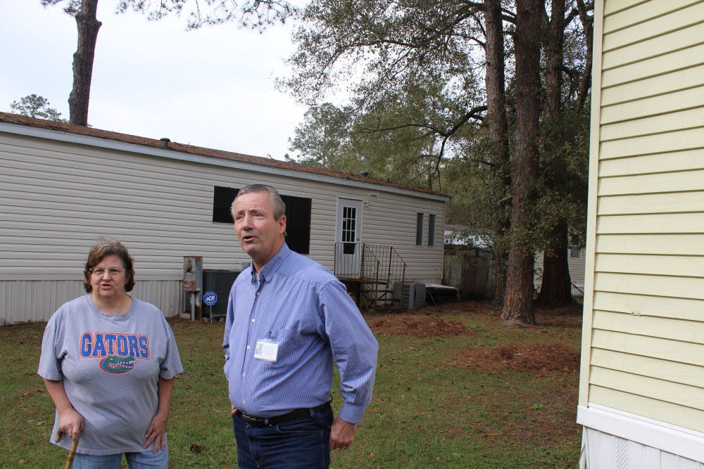 Gainesville mayoral candidate Donald Shepherd Sr. (right) and his wife, Nancy, speak outside his Gainesville home Wednesday afternoon. Gainesville Police say he stole a truck in August, and arrested him Wednesday morning. 