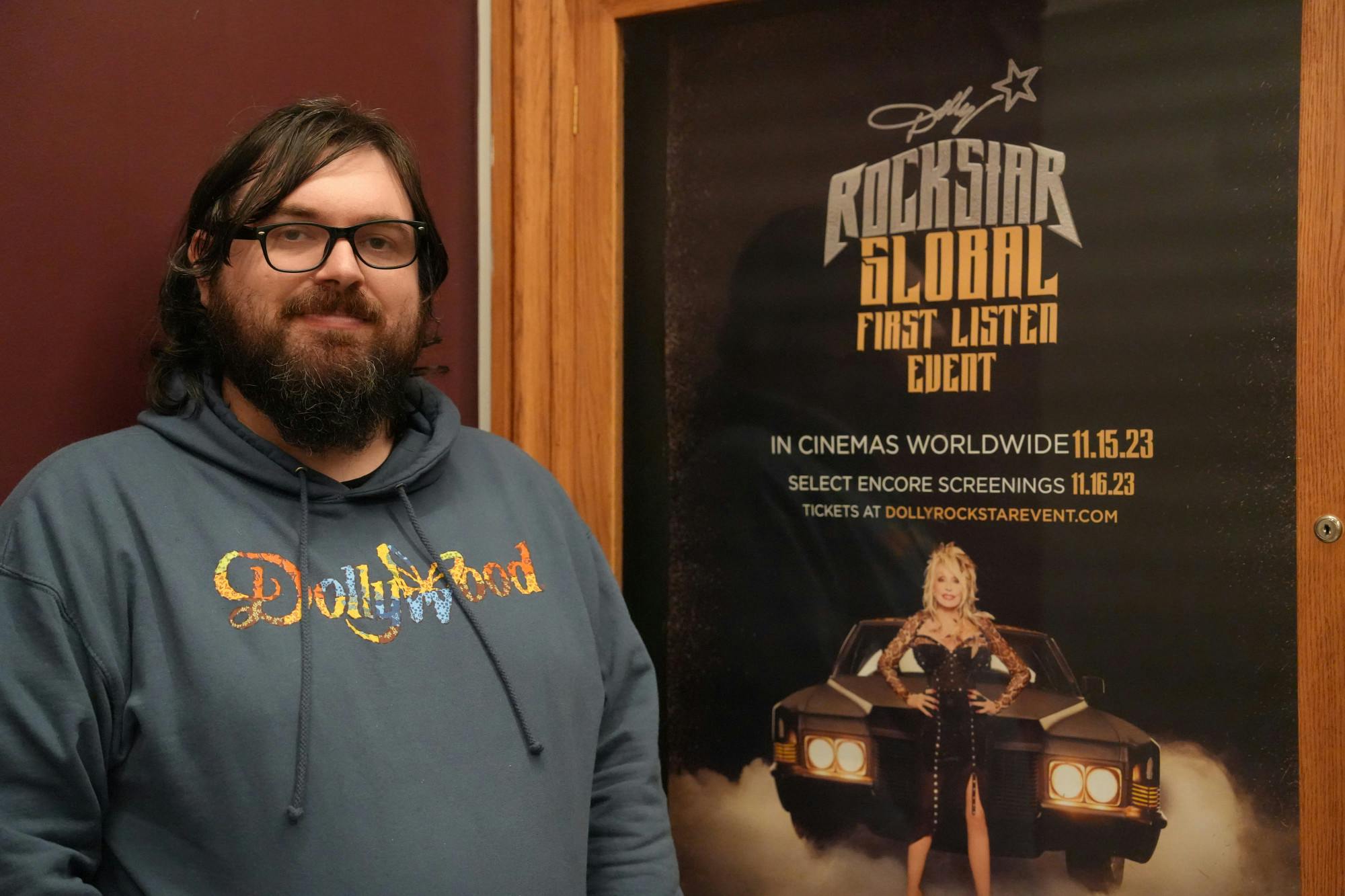 Matt Dibble, 33-year-old Hippodrome Theatre box office worker, sported his new Dollywood sweatshirt as he welcomed excited guests to the premiere Nov. 15, 2023 at The Hippodrome Theatre in Gainesville, Fla.