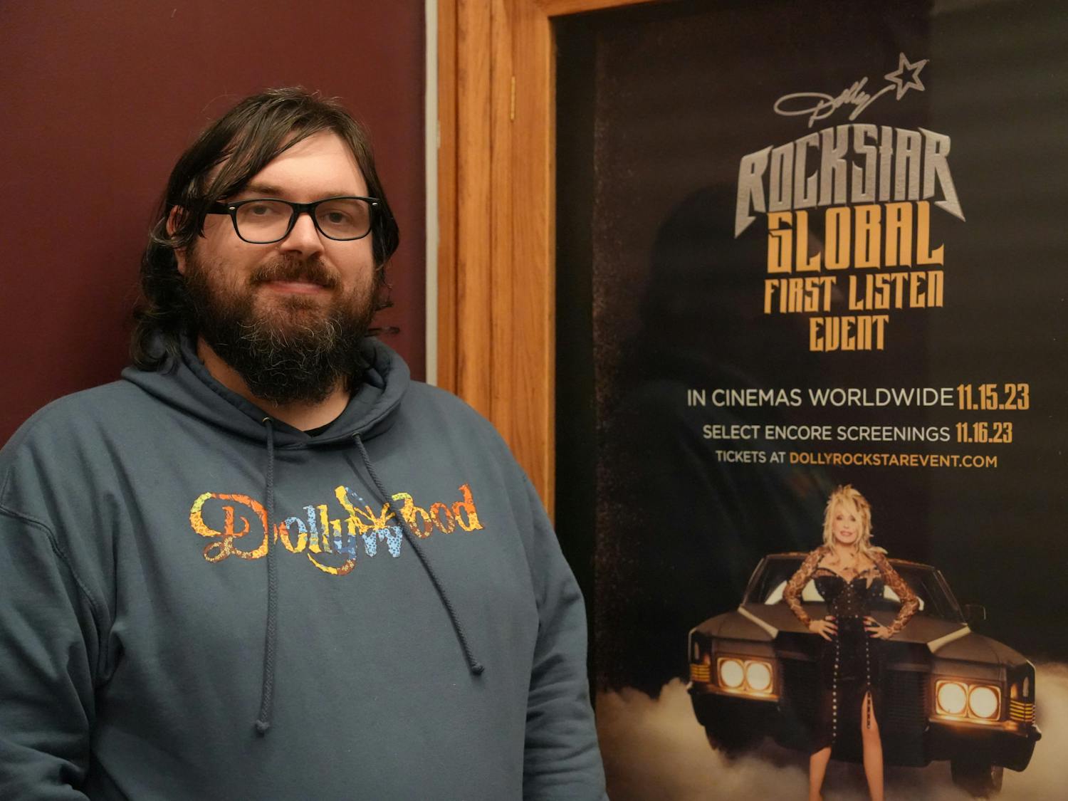 Matt Dibble, 33-year-old Hippodrome Theatre box office worker, sported his new Dollywood sweatshirt as he welcomed excited guests to the premiere Nov. 15, 2023 at The Hippodrome Theatre in Gainesville, Fla.