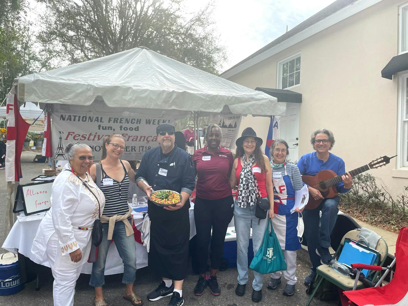 Alliance Francaise leaders stand in front of their booth at the Roots and Herbs Festival Saturday, April 8, 2023.