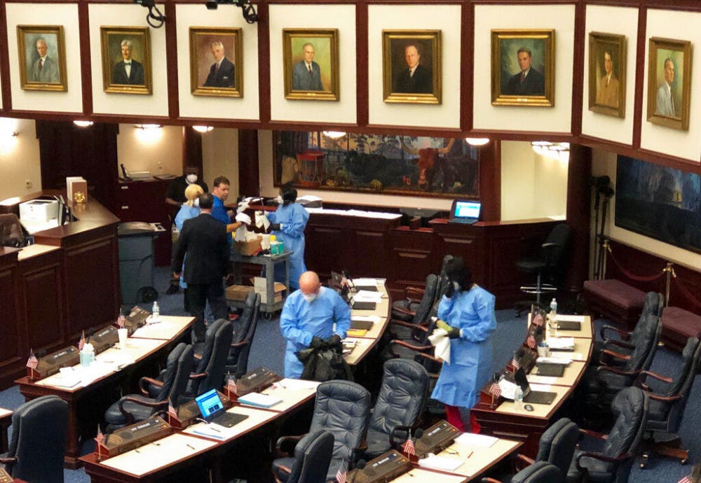 <p>Crew members swab down Florida's House floor at the state Capitol in Tallahassee, Fla., Monday, March 9, 2020, after several members voluntarily submitted themselves for testing of a new strain of coronavirus. The Florida House abruptly recessed Monday afternoon and cleared public galleries after several of its members agreed to be tested for the new strain of coronavirus after recently attending a political event in Washington where one attendee tested positive for COVID-19. (AP Photo/Bobby Caina Calvan)</p>