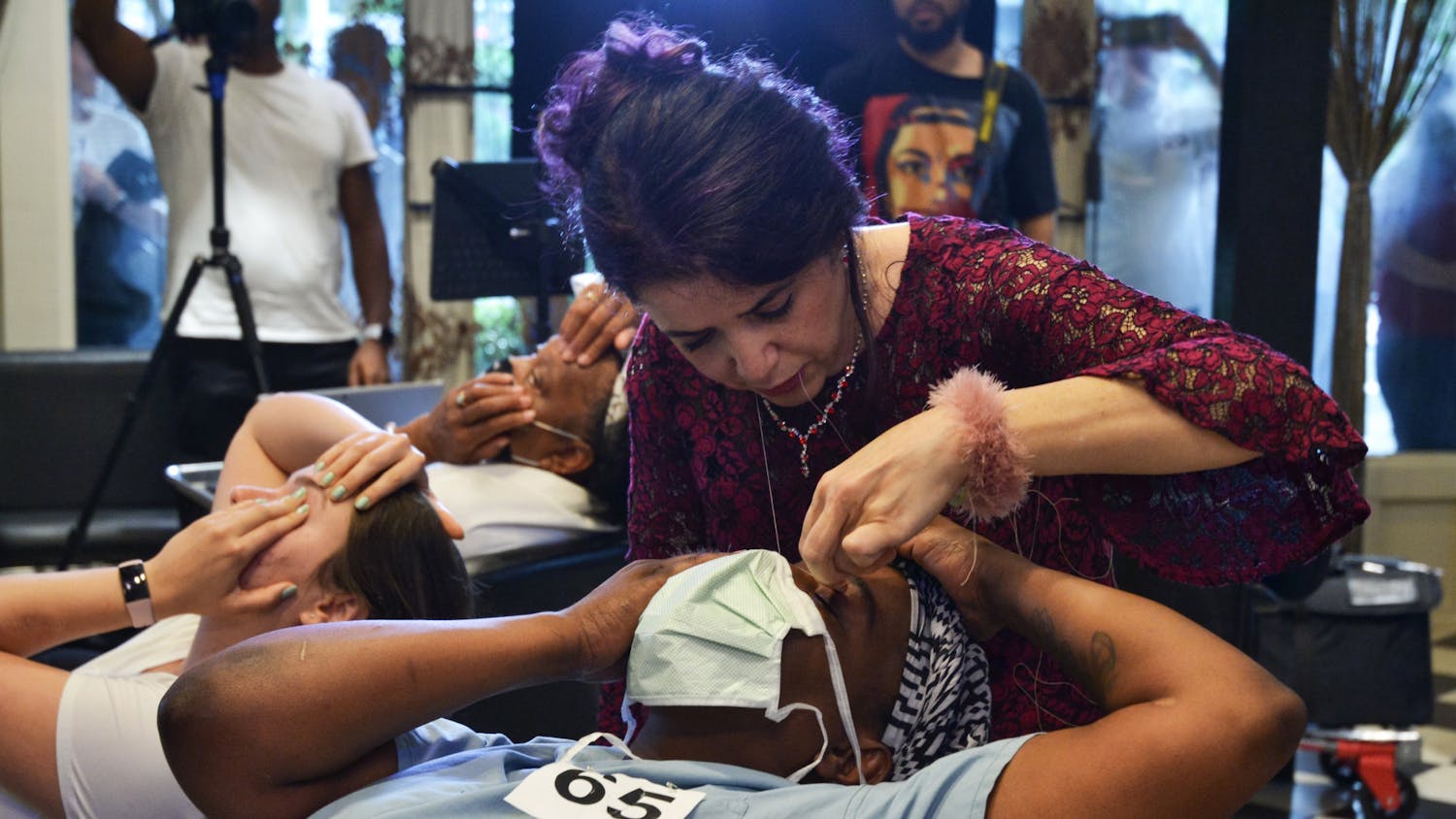 Ziba Ahmadi, owner of Salon Ziba in Gainesville, threads Shavonne Carter's eyebrows, and breaks the previous record for most eyebrows threaded by one person in one hour on Wednesday, June 16, 2021.
