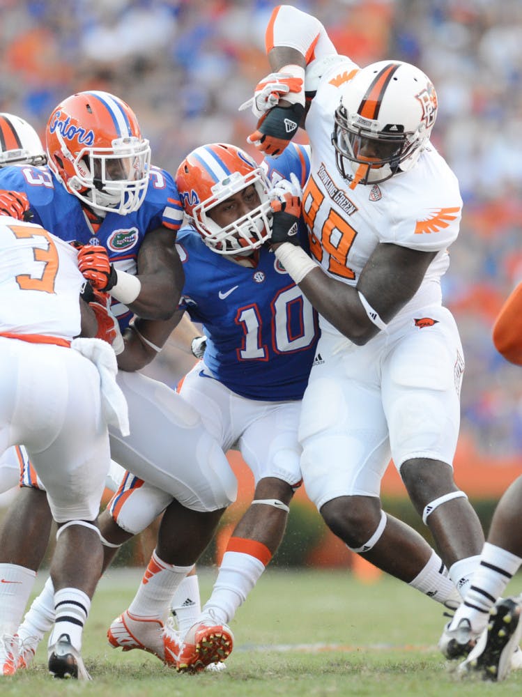 Valdez Showers battles a Bowling Green defender in Florida’s 27-14 win on Sept. 1. Showers moved from safety to tailback during the offseason.