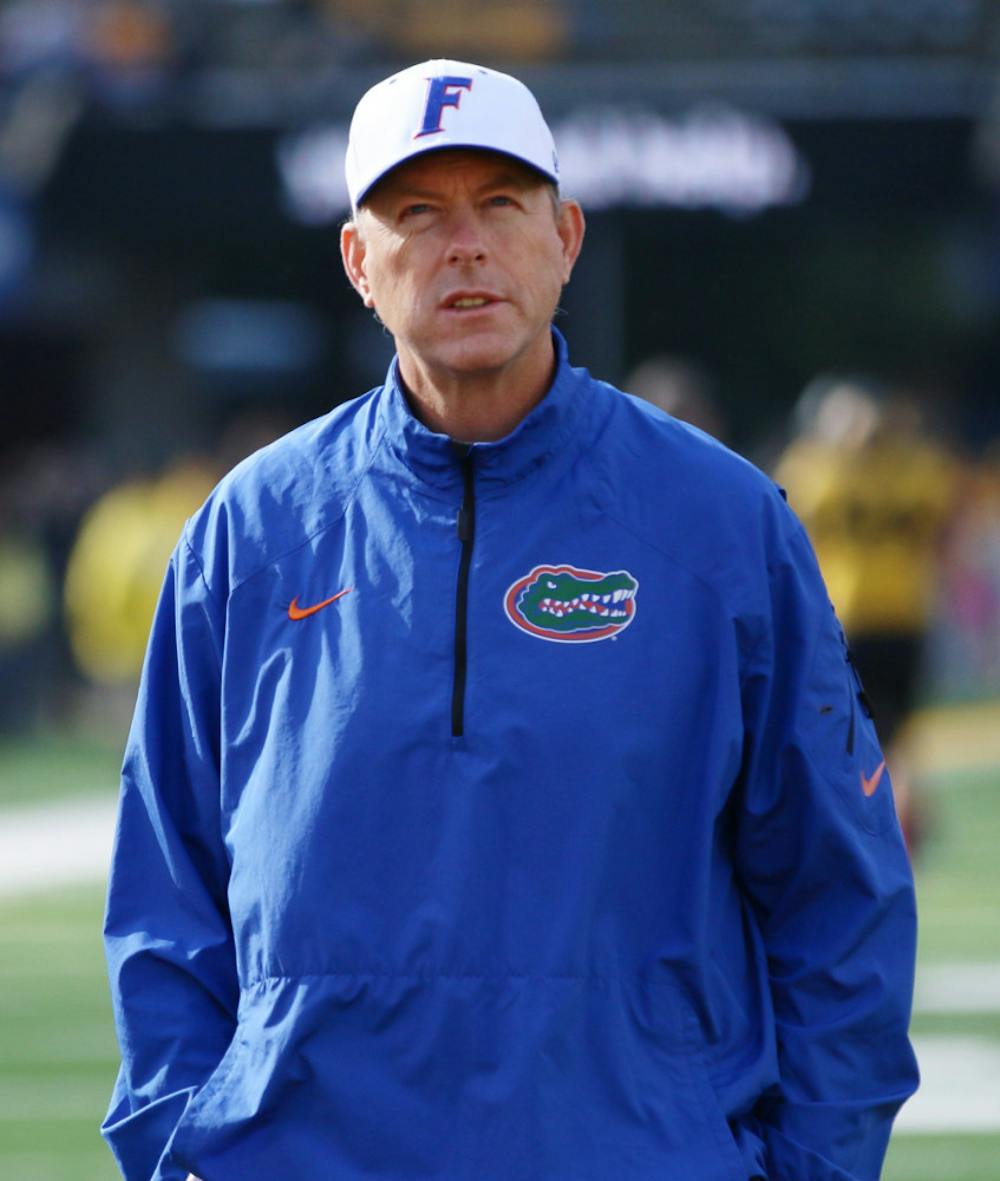 <p>Offensive coordinator Brent Pease watches warm-up drills prior to Florida’s 36-17 loss to Missouri on Oct. 19 at Faurot Field in Columbia, Mo.</p>