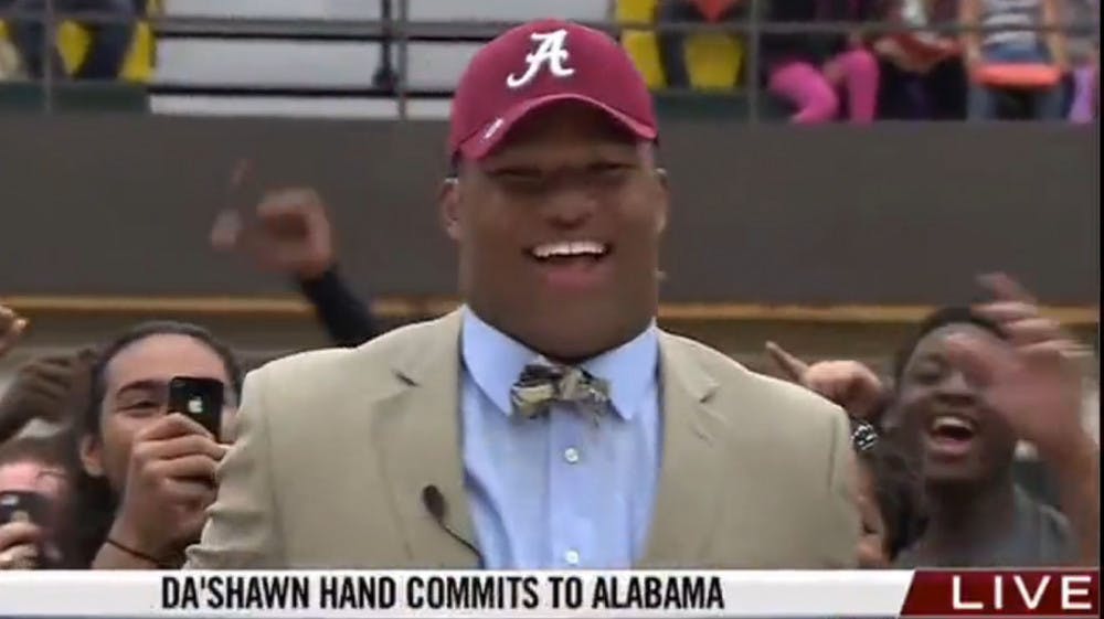 <p>Da’Shawn Hand, the No. 1 recruit in the Class of 2014 according to Rivals.com, celebrates after committing to Alabama over Florida and Michigan on Thursday afternoon at a ceremony at Woodbridge (Va.) Senior High.</p>