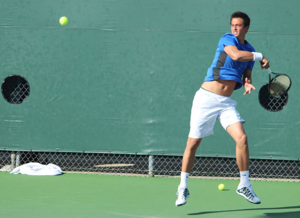 <p>Florent Diep swings at the ball during Florida’s 4-2 win against TCU on Jan. 26 at the Ring Tennis Complex.</p>