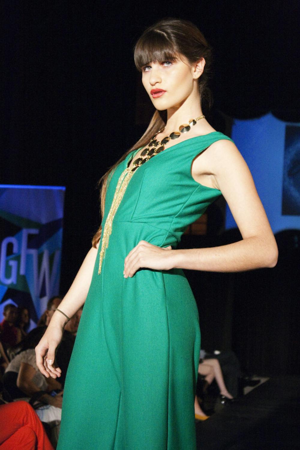 <p>A model strikes a pose during the runway shows on Saturday night as part of Gainesville Fashion Week.</p>