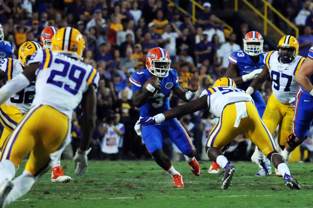 <p>UF quarterback Treon Harris attempts to elude LSU linebacker Kendell Beckwith during Florida's 35-28 loss to LSU on Oct. 17, 2015, at Tiger Stadium in Baton Rouge, Louisiana.</p>