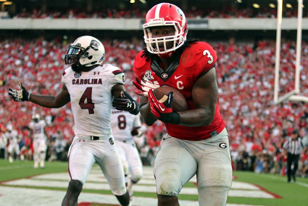 <p>Georgia tailback Todd Gurley (3) makes an 8-yard touchdown reception from quarterback Aaron Murray in front of South Carolina defender Ahmad Christian (4) in Georgia's 41-30 win against South Carolina in Athens, Ga., on Sept. 7.</p>