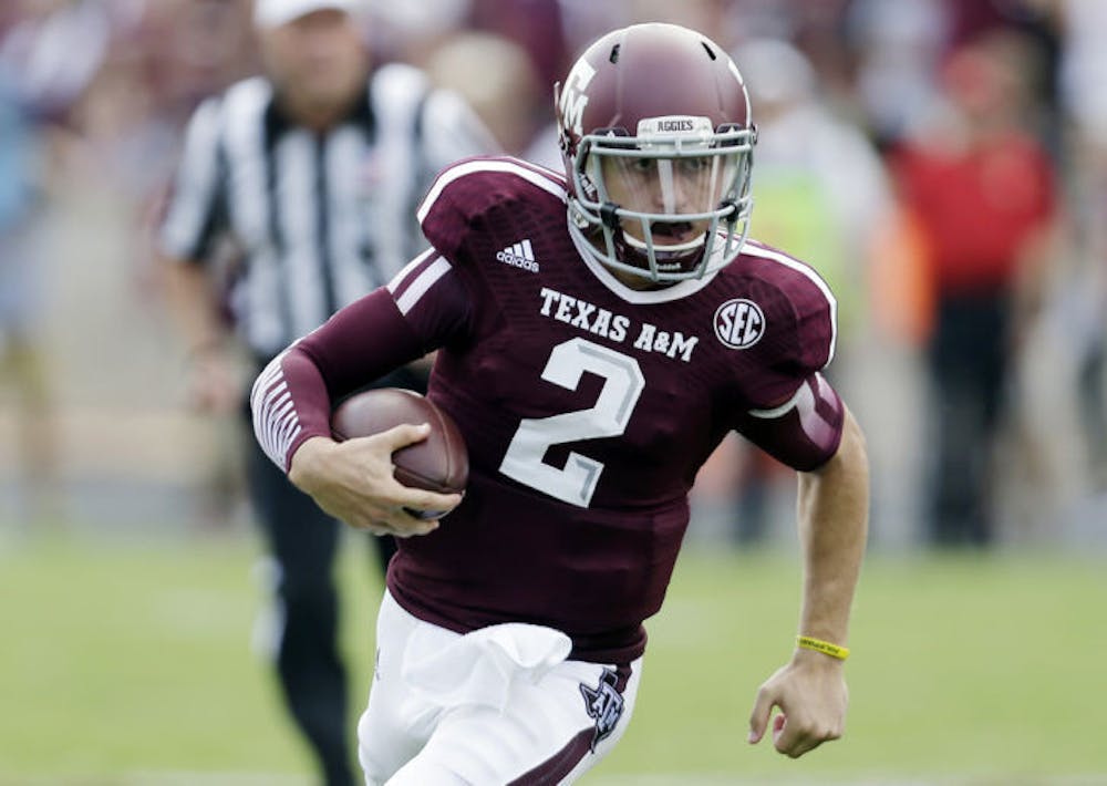<p>Johnny Manziel scrambles during the third quarter of Texas A&amp;M’s 52-31 victory against Rice on Aug. 31, 2013 in College Station, Texas.&nbsp;</p>