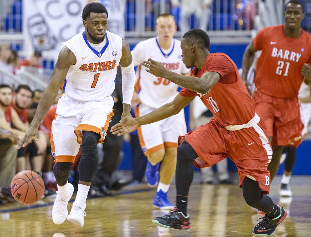 <p>Eli Carter dribbles the ball down the court during Florida's 79-70 win against Barry in an exhibition game on Thursday in the O'Connell Center.</p>
