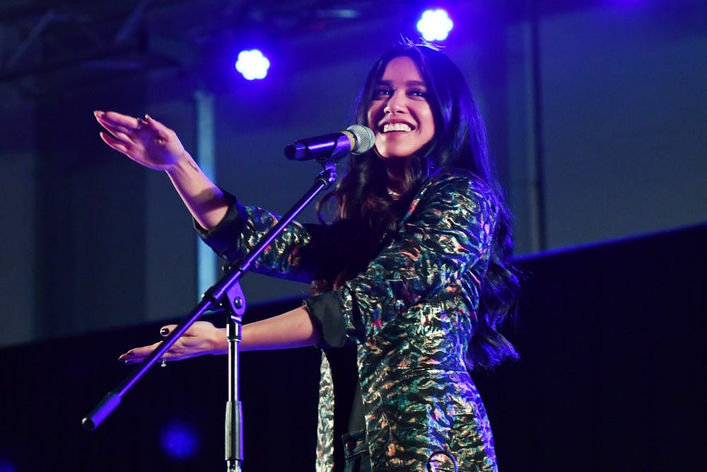 Carissa Alvarado does the Gator Chomp onstage during Friday night’s concert. She and her husband, Michael Alvarado, performed together as Us the Duo in the Reitz Union.