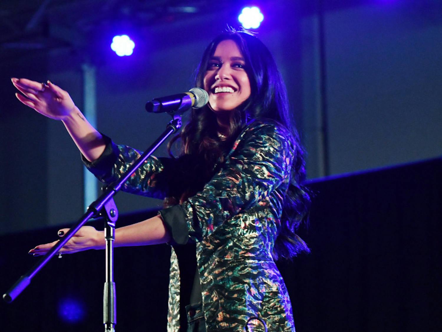 Carissa Alvarado does the Gator Chomp onstage during Friday night’s concert. She and her husband, Michael Alvarado, performed together as Us the Duo in the Reitz Union.