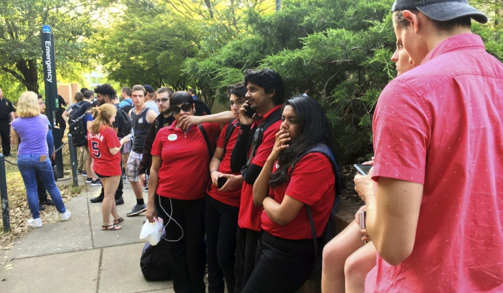 Students gather on the campus of the University of North Carolina Charlotte after a shooting Tuesday afternoon, April 30, 2019, in Charlotte, N.C.