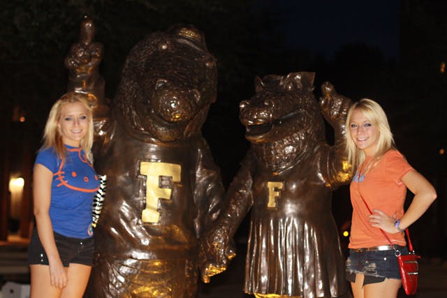 Brittany and Erica Taltos pose for a photo in front of the Albert and Alberta statue on University Avenue. The twins, who are recognized for their appearance on season four of MTV's "Jersey Shore," are trying to auction a date with themselves on eBay.