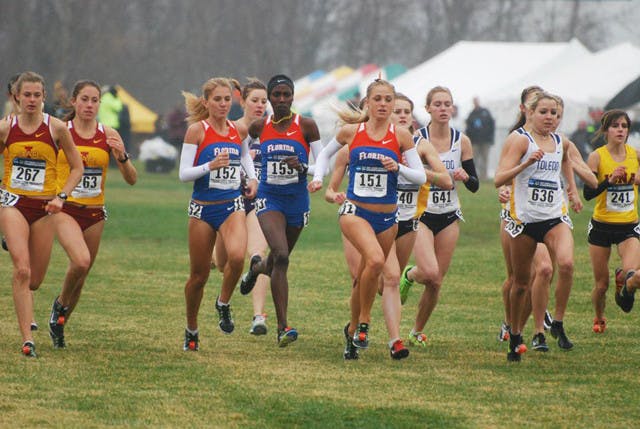 Florida distance runner Genevieve LaCaze (151) runs with team members Florence N’Getich (153) and Cory McGee (152) during the NCAA Championship race on Nov. 21. LaCaze finished in 42nd place and posted the second best time for a Gator since 1997.