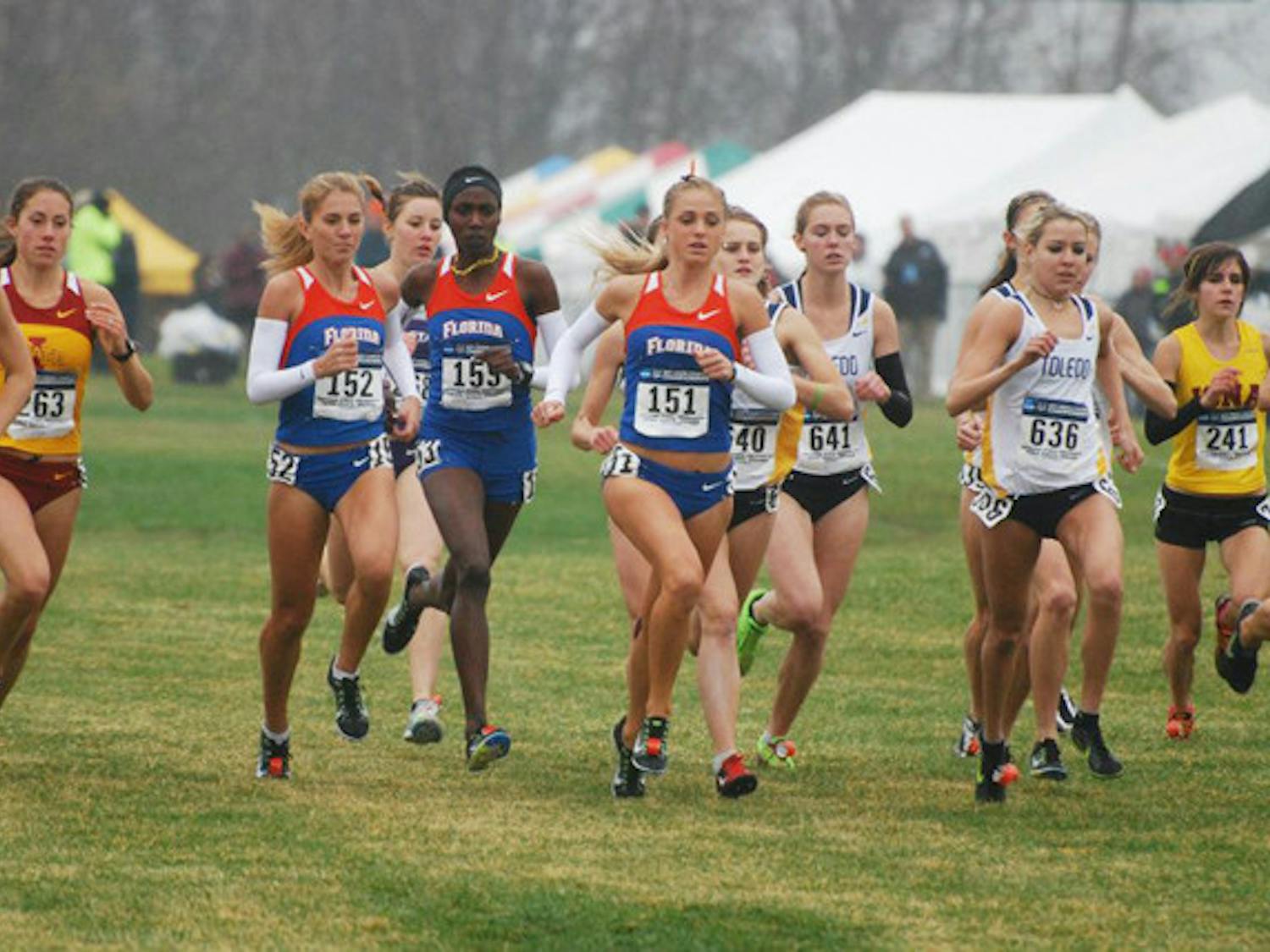 Florida distance runner Genevieve LaCaze (151) runs with team members Florence N’Getich (153) and Cory McGee (152) during the NCAA Championship race on Nov. 21. LaCaze finished in 42nd place and posted the second best time for a Gator since 1997.