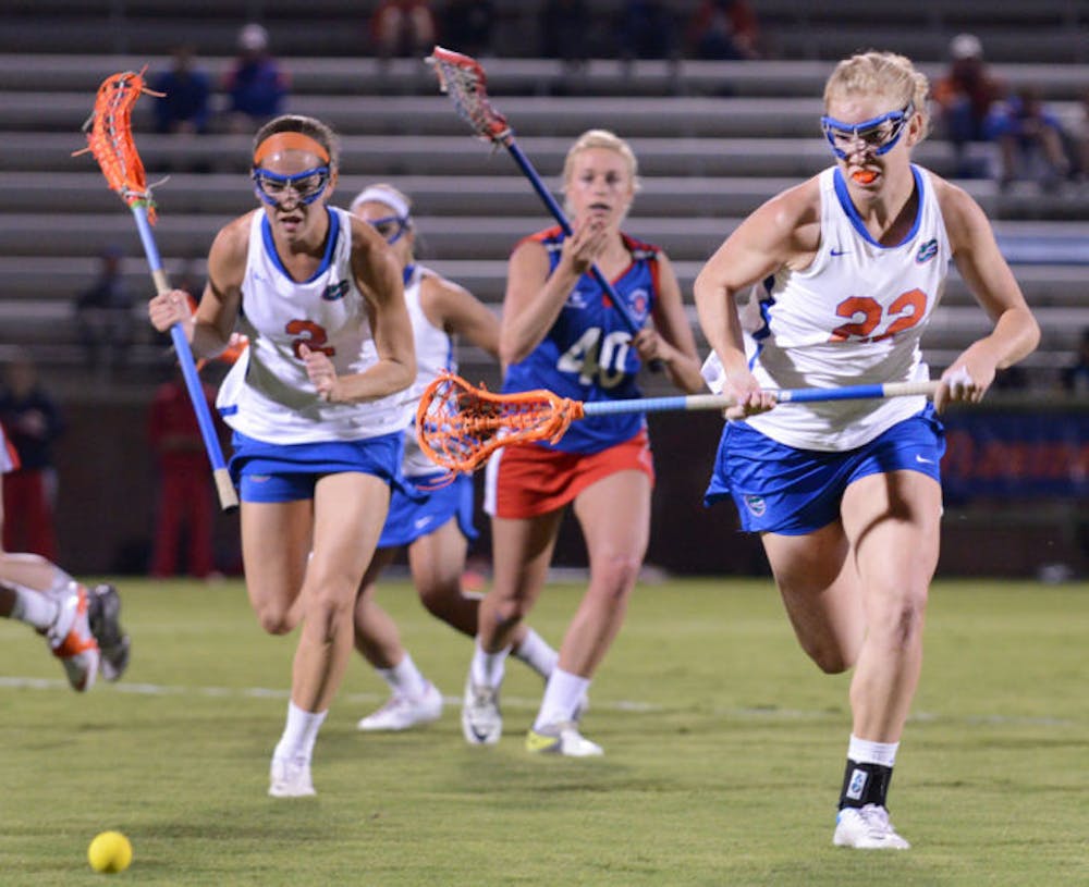 <p align="justify">Senior Brittany Dashiell (22) runs after the ball during Florida’s 18-13 exhibition win against England on Jan. 24 at Dizney Stadium. Dashiell became the first Gator to record 200 career draw controls on Saturday.</p>