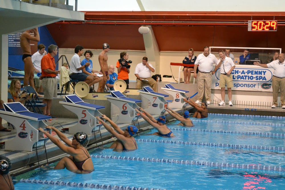 Swimmers on the UF women's swimming and diving team wait for the start of a race during Day 2 of the All-Florida Invitational on Saturday at the O'Connell Center.