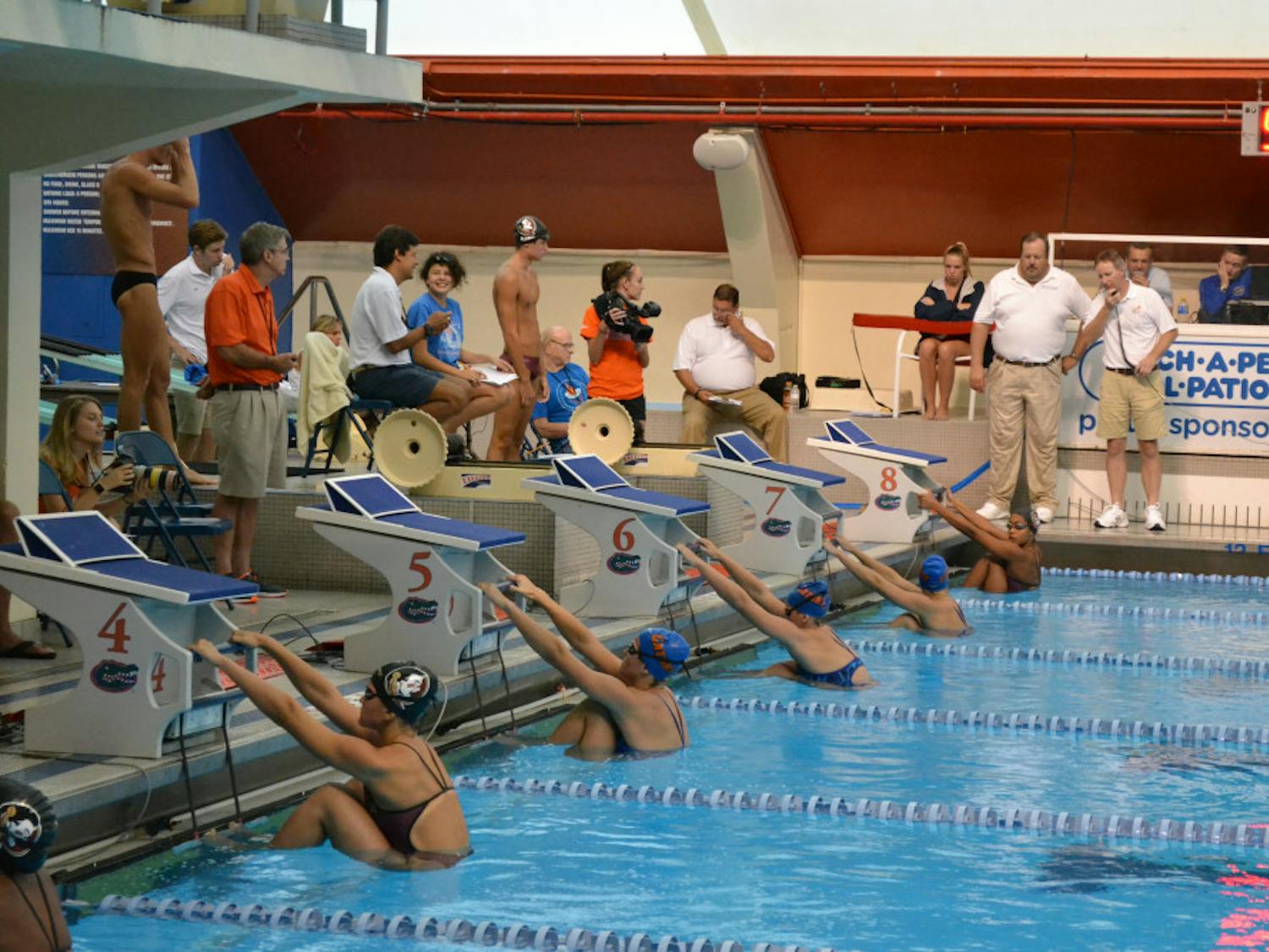 Swimmers on the UF women's swimming and diving team wait for the start of a race during Day 2 of the All-Florida Invitational on Saturday at the O'Connell Center.