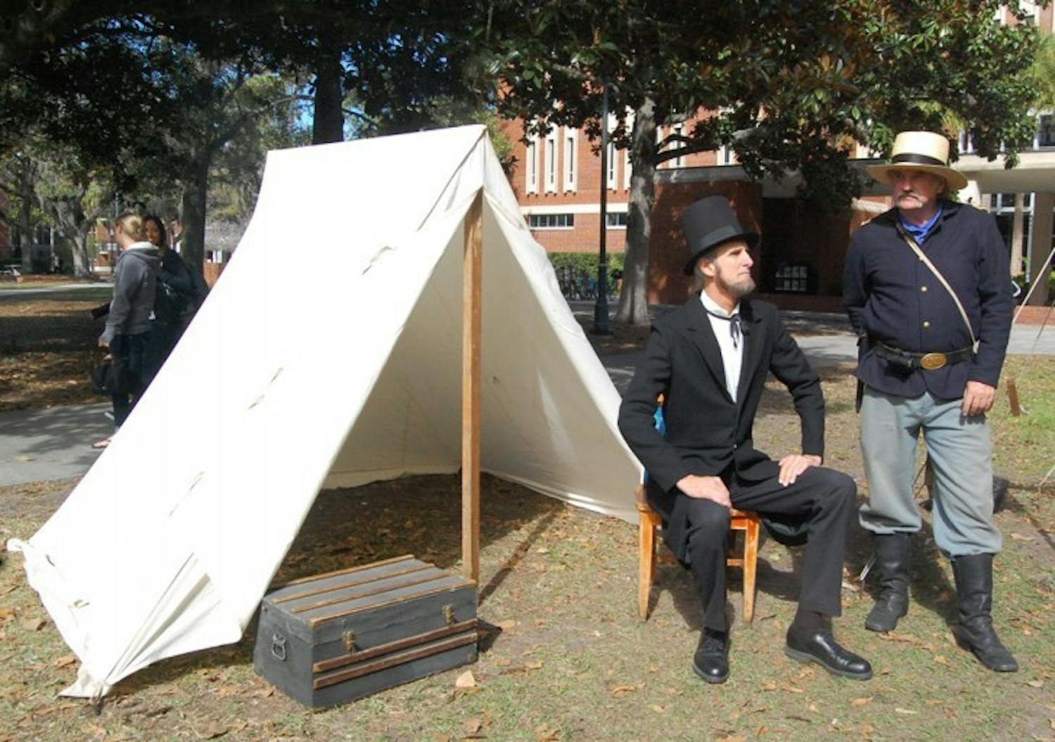 Lew Welge as Abraham Lincoln and John McLean as a 1st Lieutenant Union Soldier act on the Plaza of the Americas on Monday afternoon. The reenactment was part of a national traveling exhibit, "Lincoln: The Constitution and the Civil War," which is on display on the third floor of Library West until March 7.