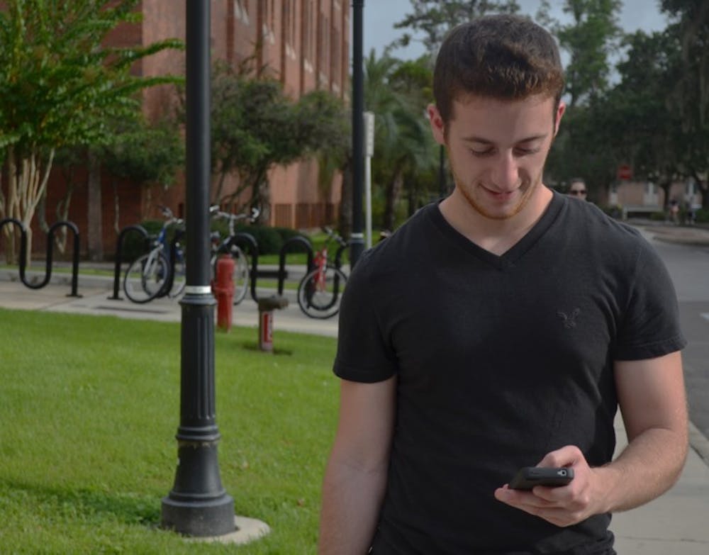 <p>UF computer science and engineering senior Bryan Dubno, 22, the creator of UFmobile, uses the free iPhone app on campus. The app includes an interactive campus map to help students find their classes.</p>